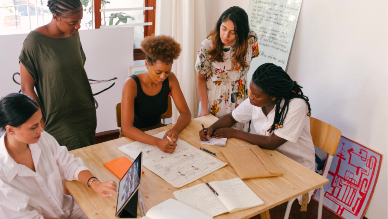 A facilitator assists a group of adult learners