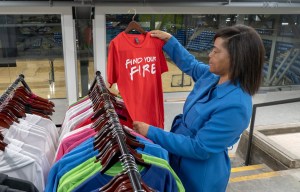 Kansas City entrepreneur Thaila Cherry holds a shirt that reads, "Find Your Fire"