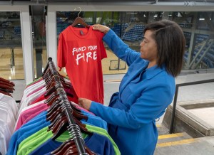 Kansas City entrepreneur Thaila Cherry holds a shirt that reads, "Find Your Fire"