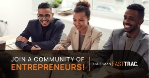 Three young adults wearing blazers sit at a table together smiling in a brightly lit room. The text overlay reads: "Join a community of entrepreneurs! Kauffman FastTrac"