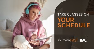 A person with pink hair wearing blue headphones takes notes during an online class while sitting at home. The text overlay reads: "Take classes on your schedule: Kauffman FastTrac."